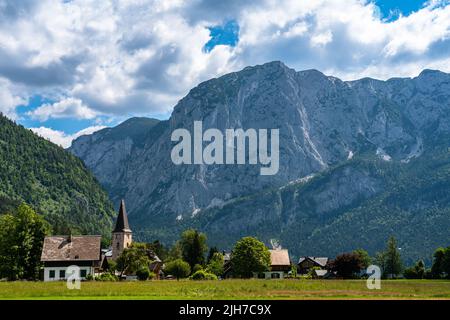 Splendida vista panoramica idilliaca della città di Altaussee con la cima Trisselwand sullo sfondo in una giornata estiva soleggiata con la nuvola blu del cielo, Salzkammergut-Aus Foto Stock