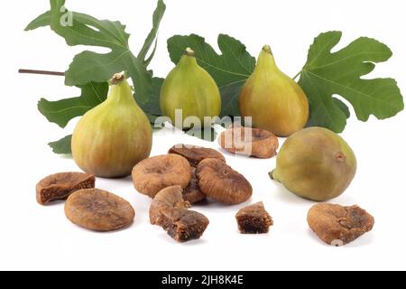 Fichi freschi e secchi con foglie isolate su sfondo luminoso. Vista ravvicinata. Foto Stock