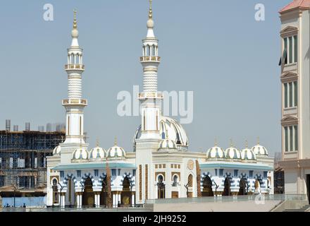 Una bella moschea bianca e blu con cupole multiple e minareti contro il cielo blu estivo, un luogo per i musulmani per compiere la loro preghiera ad Allah AS Foto Stock