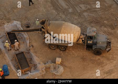 Carrello concrete scivolo bagnato di colata cementizia nella benna di metallo a prepararsi per un altro processo. Foto Stock