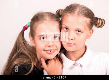 Carina ragazza felice in nero e bianco t-shirt su sfondo bianco. Foto Stock