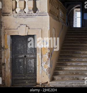 Interno storico del castello con vecchia porta in legno e scalinata in pietra a Holíč, Slovacchia. Foto Stock