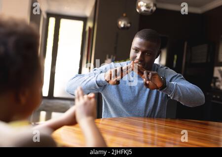 Immagine di felice padre e figlia afroamericana che gioca le dita giochi Foto Stock
