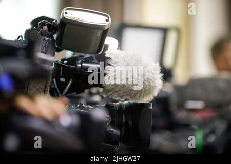 Profondità di campo poco profonda (messa a fuoco selettiva) dettagli con i microfoni e gli obiettivi delle telecamere di notizie durante un evento stampa Foto Stock