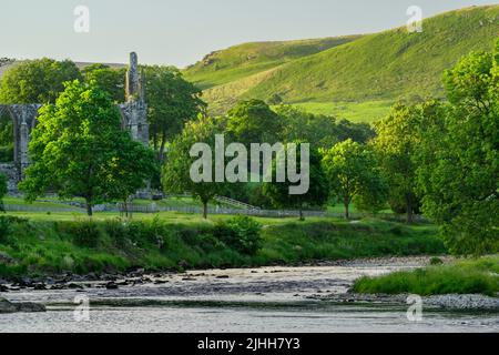 Bolton Abbey (splendida rovina storica lungo il fiume, fiume tortuoso, colline ondulate al sole, serata estiva) - Wharfedale Yorkshire Dales, Inghilterra, Regno Unito Foto Stock