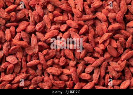 Bacche di goji essiccate chiudono la cornice come sfondo Foto Stock