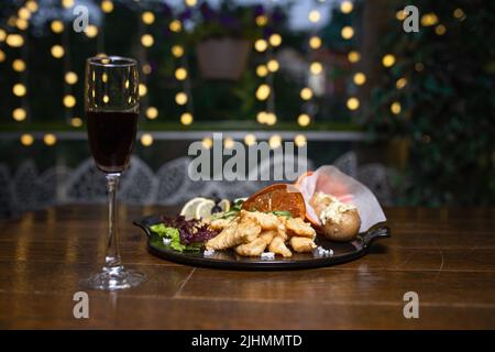 antipasto in pastella con patate su un piatto nero Foto Stock