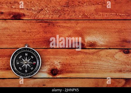 Bussola di navigazione su sfondo tavolo in legno Foto Stock