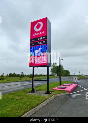 Reykjavik, Islanda - 15. Luglio 2022: Un distributore di benzina islandese della società Orkan - logo della società e prezzi della benzina nel paesaggio islandese Foto Stock