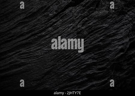 Tessitura di vecchio legno nero. Primo piano della texture di rovere nero scuro. Trama in legno sinuoso con ombra. Foto Stock