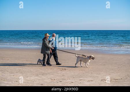 Adelaide Australia 21 luglio 2022. Persone che camminano il loro cane nel caldo sole invernale lungo la riva dell'oceano nel sobborgo costiero di Brighton Adelaide Credit. amer Ghazzal/Alamy Live News Foto Stock