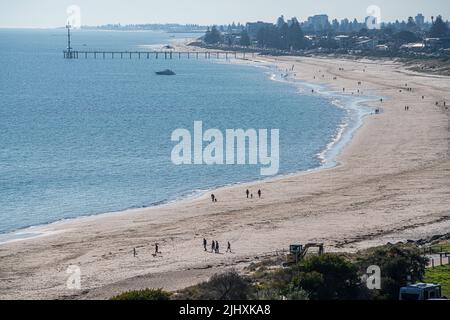 Adelaide Australia 21 luglio 2022. Peple godersi la calda passeggiata sulla spiaggia nel sole d'inverno nel sobborgo costiero di Brighton Adelaide Credit. amer Ghazzal/Alamy Live News Foto Stock