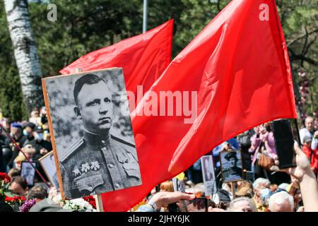 Odessa, Ucraina. 09th maggio 2021. Una targa con un ritratto di un uomo che ha combattuto nella seconda guerra mondiale sullo sfondo di una bandiera rossa durante l'evento. Il 9 maggio 2021, l'Ucraina ha celebrato il 76th anniversario della vittoria sul nazismo nella seconda guerra mondiale; la gente ha onorato la memoria dei morti posando fiori al monumento al marinaio ignoto sulla Walk of Fame nel parco. T.G. Shevchenko. (Foto di Viacheslav Onyshchenko/SOPA Images/Sipa USA) Credit: Sipa USA/Alamy Live News Foto Stock