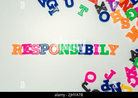 Parola di responsabilità composta da lettere colorate in plastica su sfondo bianco Foto Stock