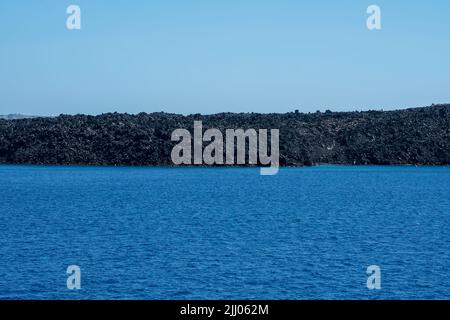 Vista ravvicinata dell'isola di origine vulcanica, Nea Kameni, che si è formata su ripetute eruzioni di lava dacite e cenere a Santorini Foto Stock