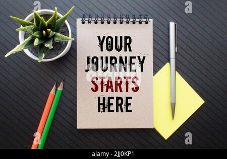 Texte sur Your Journey starts here on noteboock Foto Stock