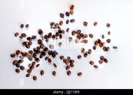 Chicchi di caffè in volo su sfondo bianco sfocato, sfocato, fatto da due foto con spazio di copia. Concetto compromissione mentale stato, confusione. Morn Foto Stock