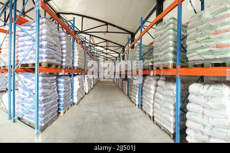 Grandi magazzini di sacchi di alimentazione animale. Produzione veterinaria. Alimentazione animale in stock. Pallet con carico Foto Stock