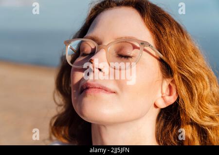 Ladybug seduto sul naso della donna Foto Stock