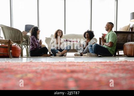 Colleghi di lavoro felici che meditano in ufficio Foto Stock