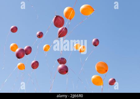 volare palloncini colorati al cielo. cielo blu da persone felici. Rilasciare palloncini a festa celebrazione Foto Stock
