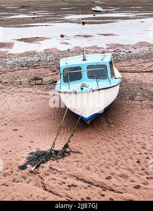 A vertical shot of a boat parked on a sandy beach Stock Photo