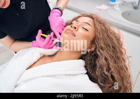 Il cosmetologo fa iniezioni di tossina botulinica in clinica di medicina estetica Foto Stock