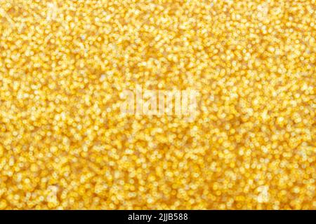 Oro chiaro brillante bokeh sfondo sfocato astratto con brillante sfocatura circolare motivo dorato. Foto Stock