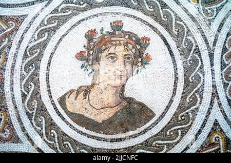Un primo piano di un volto su un mosiaco romano esposto al Museo Archeologico di El Jem in Tunisia. Foto Stock