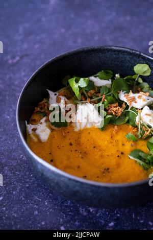 Zuppa di carote arrosto, crescione, mozzarella, cipolla croccante Foto Stock