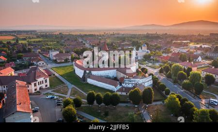 Prejmer, Romania. Sunrise ora d'oro vista aerea drone della chiesa fortificata Prejmer. Sito patrimonio dell'umanità dell'UNESCO in Transilvania. Foto Stock