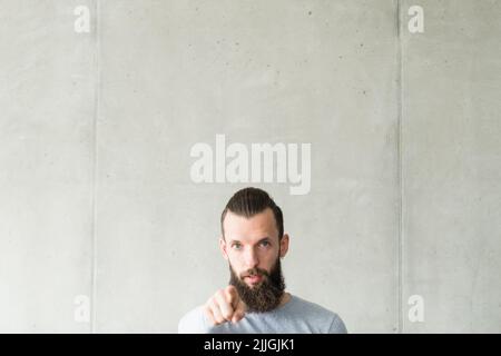 giudica la colpa scettico hipster ragazzo puntando dito Foto Stock