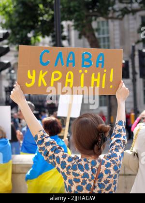 Londra, Regno Unito - 26 giugno 2022: Sostenitore dell'Ucraina che tiene il poster "Glory to Ukraine" vicino a Downing Street Foto Stock