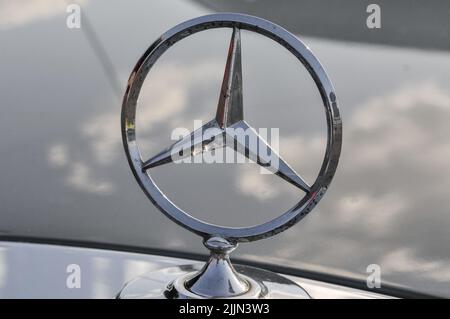 Primo piano del logo della stella Mercedes Benz sul vecchio cofano dell'automobile Foto Stock