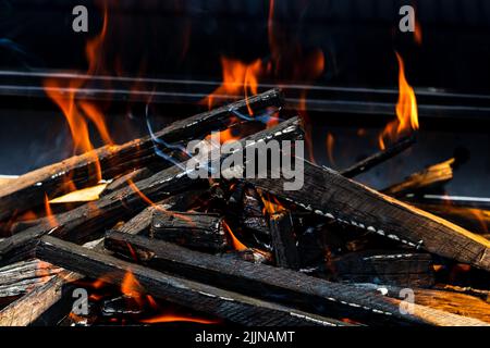 Barbecue buca griglia con incandescente e fiammeggiante fuoco caldo aperto con fiamma rossa Foto Stock