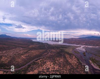 An aerial view of the Lake Roosevelt and the forested areas near the shore under the cloudy sky Stock Photo