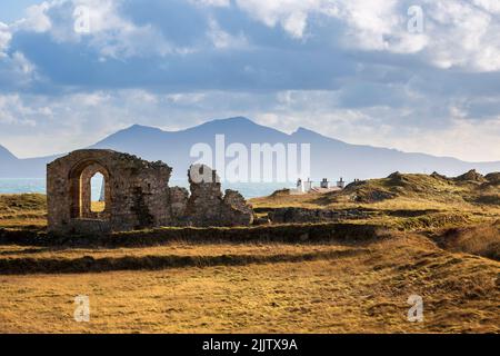 Le rovine della chiesa di St Dwynwen sull'isola di Llanddwyn, Anglesey, Galles del Nord Foto Stock