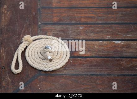 corda avvolta sul ponte di una nave Foto Stock