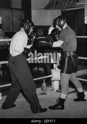 Un campione lo aiuta sulla strada verso il campionato - Jackie Paterson, ex campione del mondo, (a sinistra) sparring, con Danny o'Sullivan a Brighton, Sussex, dove lo aiuta con la sua formazione . Danny combatterà Louis Ramero per il titolo europeo del peso di Bantam il 24th aprile. Quando Paterson combatté o'Sullivan lo bussò al settimo giro, quindi si pensò che fosse una buona idea che quest'ultimo dovesse dare al primo qualche consiglio per la sua prossima battaglia. Aprile 18, 1950. (Foto di Paul Popper Ltd.). Foto Stock