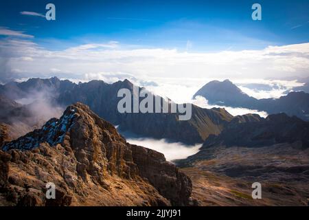 Zugspitze, la vetta della Germania e dei Monti Wetterstein catturati con dense nuvole e cielo blu, Garmisch-Partenkirchen al confine Austria-Germania Foto Stock