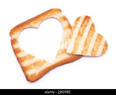 Pane tostato con segni del grill e foro a forma di cuore isolato su sfondo bianco Foto Stock