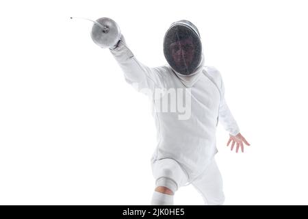 Ritratto dinamico del giovane uomo, fencer in costume da scherma con la spada in mano allenamento isolato su sfondo bianco studio. Sport, energia, abilità Foto Stock