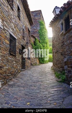 Strada stretta della città vecchia medievale con lampo di luce tra gli edifici. Patones de Arriba Madrid. Spagna. Foto Stock