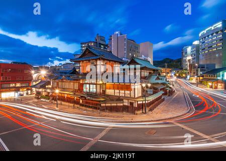 Matsuyama, Giappone skyline centro al Dogo Onsen bagno casa al crepuscolo. Foto Stock