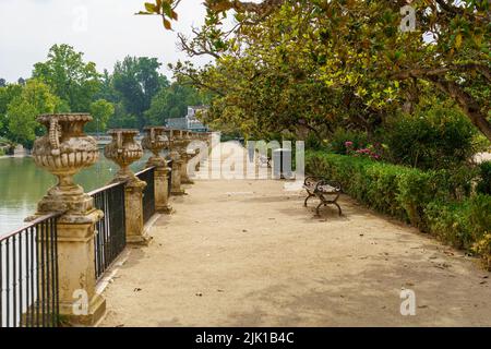 Strada sterrata nel parco vicino al fiume Tago e persone a piedi e riposo. Aranjuez. Foto Stock