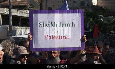 Gerusalemme, Israele. 29th luglio 2022. GERUSALEMME, ISRAELE - 29 LUGLIO: Un attivista di sinistra israeliano ha un cartello con la scritta "Sheikh Jarrah is Palestine" durante una manifestazione contro l'occupazione israeliana e l'attività di insediamento nel quartiere di Sheikh Jarrah il 29 luglio 2022 a Gerusalemme, Israele. Il quartiere palestinese di Sheikh Jarrah è attualmente il centro di una serie di controversie di proprietà tra palestinesi e israeliani ebrei di destra. Alcune case sono state occupate dai coloni israeliani a seguito di una sentenza della Corte. Credit: Eddie Gerald/Alamy Live News Foto Stock