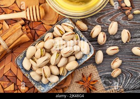 gruppo di pistacchi su sfondo di legno Foto Stock