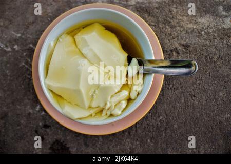 Wedang Tahu o Kembang Tahu è una bevanda allo zenzero e contiene bean curd (tofu) a base di succo di soia e sciroppo di zucchero di palma. Tradizionale budino tofu Foto Stock