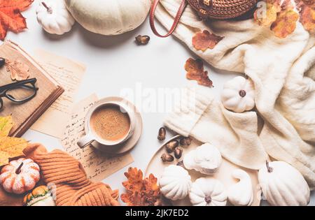 Caffè caldo con zucche e foglie colorate su sfondo bianco vista dall'alto. Elegante appartamento autunnale. Ciao autunno. Immagine calda e accogliente Foto Stock