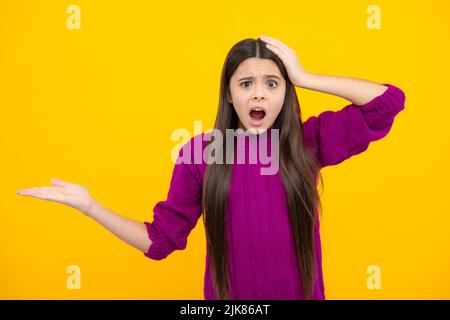 Divertente teenager punti bambino a parte con espressione allegra, mostra stupefacente a vuoto spazio vuoto. Pubblicità e mockup. Stupito emozioni di giovani Foto Stock